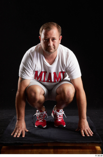  Louis  2 dressed grey shorts kneeling red sneakers sports white t shirt whole body 0001.jpg